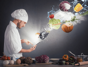 Un homme regarde une recette sur une tablette et des ingrédients semblent jaillir de son écran pour composer une recette.